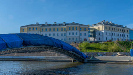 New pedestrian bridge construction over river in city. construction site. blue sky. urban concepts.の写真素材