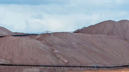 Mountains of empty ore when mining potassium. Transportation of an empty rock to a dump. View of the...