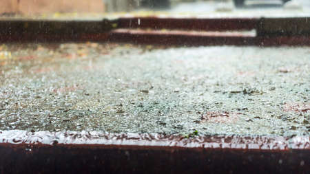 Raindrops in the water. Aqua abstract background. Rain drops on the surface of water in a puddle. Heavy rain drops on asphalt. rain in the city.の写真素材
