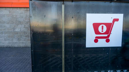 Sign of shopping trolleys parking lot. Shopping carts return point on a parking lot near...