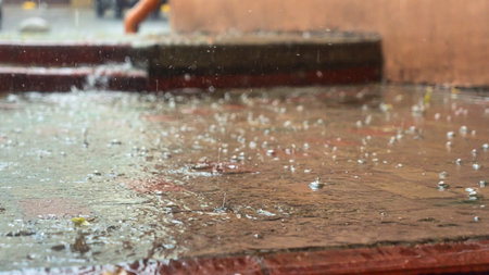 Raindrops in the water. Aqua abstract background. Rain drops on the surface of water in a puddle. Heavy rain drops on asphalt. rain in the city.の写真素材