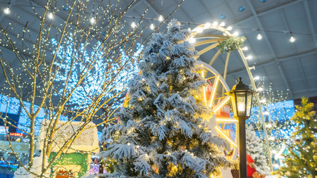 Capture the festive spirit of the holiday season with this vibrant image showcasing a beautifully decorated Christmas tree in a bustling shopping mall. The tree, adorned with colorful ornaments, twinkling lights, and shimmering garlands. Perfect for use in holiday marketing campaigns, greeting cards, or social media promotions, this image encapsulates the essence of festive shopping and family gatherings during the most wonderful time of the year.の写真素材
