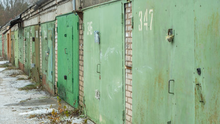 An old garage cooperative featuring vintage garages and weathered doors, showcasing a nostalgic atmosphere and the charm of bygone craftsmanship in a rustic setting.の写真素材