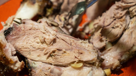 Succulent homemade pork knuckle, perfectly roasted and sliced, showcasing its crispy skin and tender meat, ideal for a hearty meal or festive gathering.の写真素材