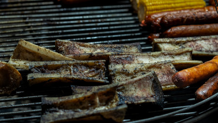 Sizzling sausages and sweet corn grilling over an open flame, creating a mouthwatering feast....