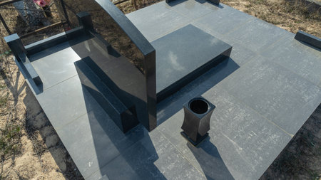 Gravestones at a quiet cemetery honor the memory of loved ones, symbolizing faith, resurrection, and...