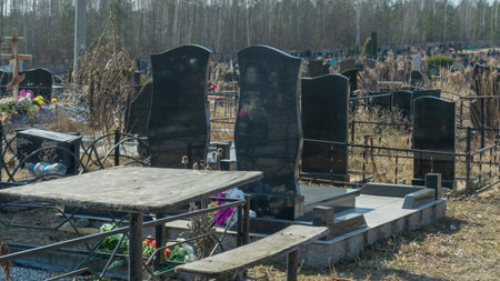Gravestones at a quiet cemetery honor the memory of loved ones, symbolizing faith, resurrection, and...