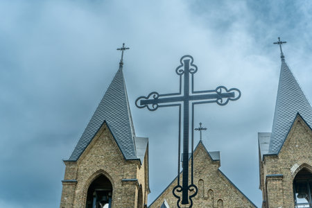 The image of St. Anne's Neo-Gothic Church in Rakow, Belarus, showcases spring's beauty with its Gothic and Classicism elements, adorned with Catholic crosses, symbolizing faith and heritage.の写真素材