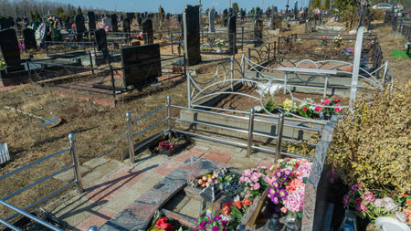 Gravestones at a quiet cemetery honor the memory of loved ones, symbolizing faith, resurrection, and...