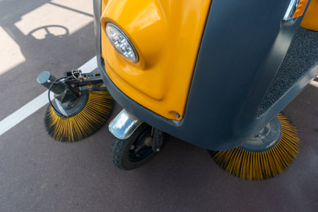 Innovative electric street sweeper efficiently cleaning pedestrian walkways and bike paths for a cleaner, greener urban environment.の写真素材