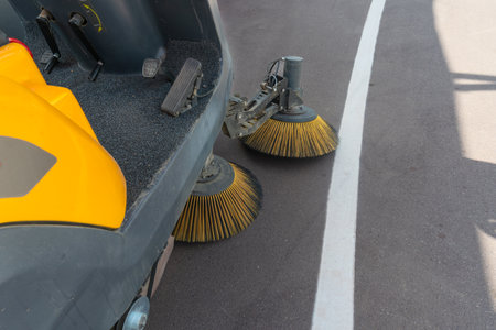 Innovative electric street sweeper efficiently cleaning pedestrian walkways and bike paths for a cleaner, greener urban environment.の写真素材
