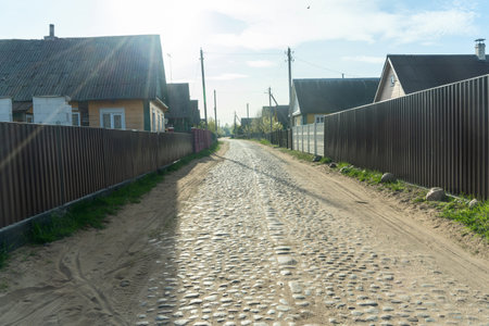 Charming old village road lined with cobblestones, showcasing rustic beauty and historical charm. A picturesque path inviting exploration and evoking nostalgia.の写真素材