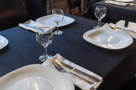 Elegant table setting for a gourmet dinner celebration with fine glassware and stylish cutlery in a...