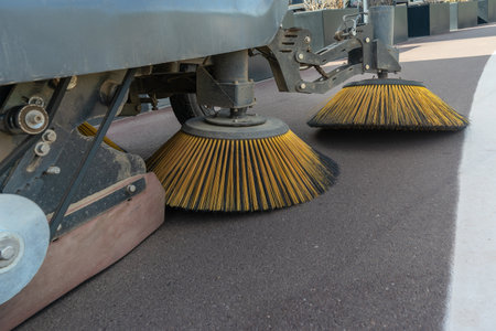 Innovative electric street sweeper efficiently cleaning pedestrian walkways and bike paths for a cleaner, greener urban environment.の写真素材