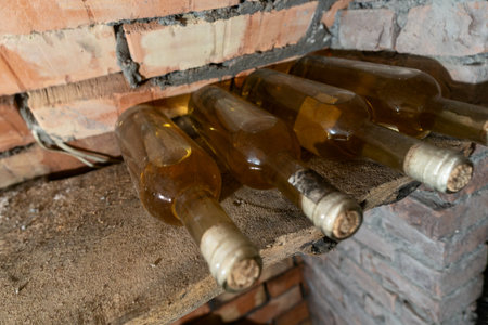 Rustic Wine Cellar Filled With Aging Bottles On Wooden Shelves. A Detailed View Of A Rustic Wine...