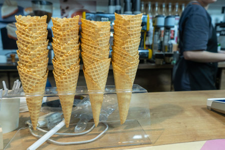 The Minimalist Beauty of Empty Waffle Cones Awaiting Sweet Creations. A Beautifully Arranged Display of Waffle Cones. Exploring the Textures and Colors of Ice Cream Cones in a Cozy Cafe Setting.の写真素材