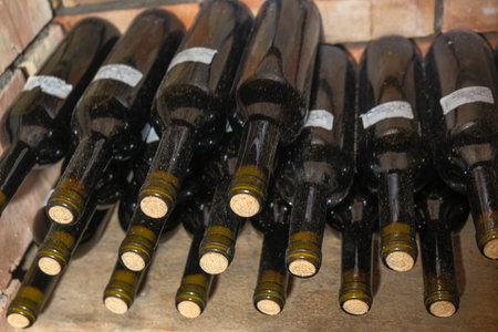 Rustic Wine Cellar Filled With Aging Bottles On Wooden Shelves. A Detailed View Of A Rustic Wine...