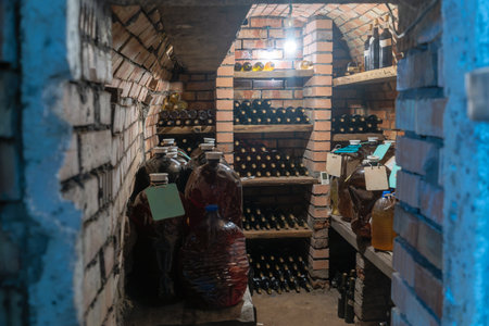 Rustic Wine Cellar Filled With Aging Bottles On Wooden Shelves. A Detailed View Of A Rustic Wine...