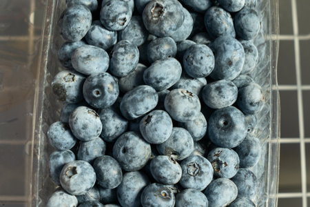 Fresh blueberries in boxes. Organic blueberries in bulk, a vibrant display of summer's natural sweetness. A visual journey through the richness of fresh blueberries.の写真素材
