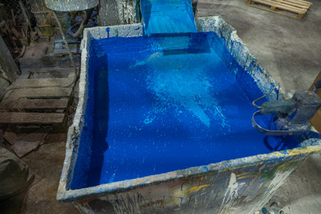 Vibrant blue paint tank in a bustling factory setting, capturing the essence of industrial artistry. The production of pentaphthalic paint. A large container in which PF paint awaits bottling.の写真素材