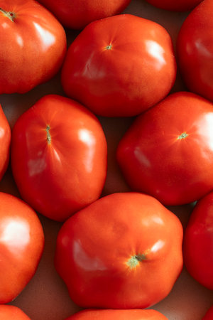 Vibrant red tomatoes symbolizing the essence of life and growth. Fresh tomatoes on display at a...