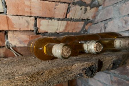 Rustic Wine Cellar Filled With Aging Bottles On Wooden Shelves. A Detailed View Of A Rustic Wine...