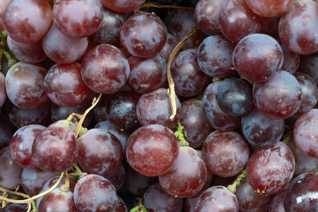 Closeup of vibrant red grape texture a sweet and juicy symphony of natures candy and natural...