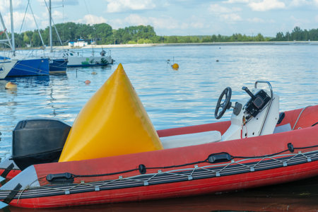 Inflatable rescue boat equipped with steering console. Safe haven for exploration a red inflatable...