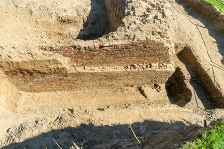Historical Ruins Unearthed Archaeology Site. Urban Archaeological Excavation Showing Old Brick Wall...