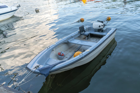 An empty motor boat drifting gently symbolizing solitude and the endless possibilities of...