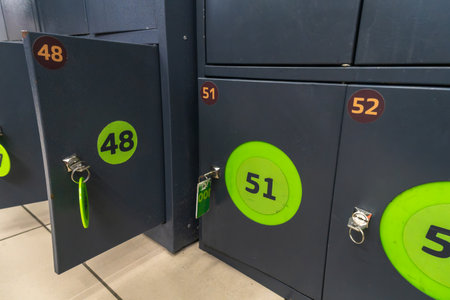 Simple locker storage with numbered keys. Secure bag storage lockers with numbered keys convenient for shoppers keeping their belongings safe while browsing in retail environments.の写真素材