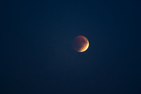 Blood red moon in night sky. Lunar eclipse in dramatic red color with a cosmic sparkle. A symbol of...