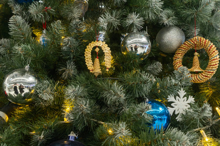 Christmas tree with blue purple and straw ornaments and glowing lights. Where reflection meets...