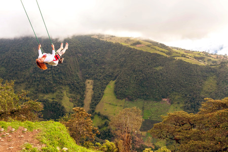 Silhouette Of A Happy Young Blonde Woman Swinging On A Swing Above The Andes Mountains