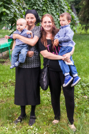 Big Happy Family In The Park, Mother, Great Grandmother, Grandmother, Grandchildren And Sonsの写真素材
