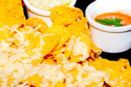Delicious Guacamole And Chili Pepper Sauce Served With Tortilla Chips Grated With Cheese Ready To Be Served On A Table, At A Restaurant In Latin Americaの写真素材