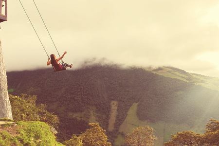 Silhouette Of An Young Happy Woman On A Swing, Swinging Over The Andes Mountains, Tree House, Ecuador, Vintage Styleの写真素材