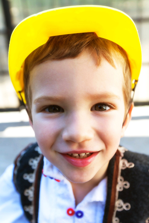 Romanian Peasant Child With A Yellow Bicycle Helmet On The Headの写真素材