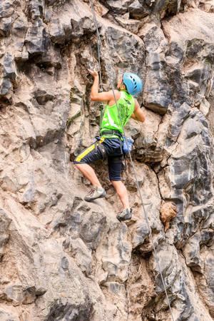 Banos, Ecuador - 30 November 2014: Basalt Challenge Of Tungurahua, Young Man Climbing A Stone Wall In Banos On November 30, 2014のeditorial素材