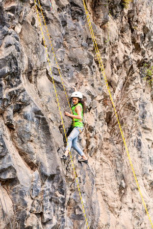 Banos, Ecuador - 30 November 2014: Basalt Challenge Of Tungurahua, Teenager Girl Climbing A Rock Wall In Banos On November 30, 2014のeditorial素材
