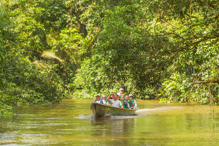 Cuyabeno, Ecuador - 20 March 2015: European Biologists In The Canoe Crossing Cuyabeno River, South America In Cuyabeno On March 20, 2015のeditorial素材