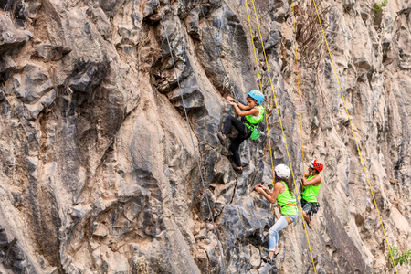 Banos, Ecuador - 30 November 2014: Basalt Challenge Of Tungurahua, Young Group Of Climbers Climbing A Rock Wall In Banos On November 30, 2014のeditorial素材