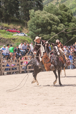 Banos, Ecuador - 30 November 2014: Young Latin Cowboy Throwing A Lasso, South America Competition In Banos On November 30, 2014のeditorial素材