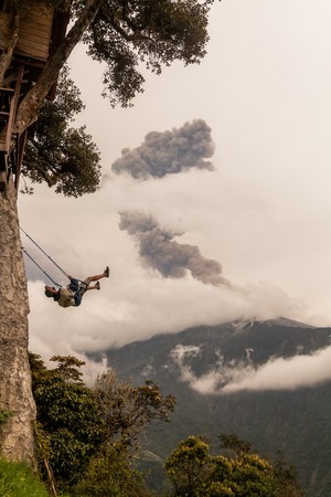 Banos De Agua Santa, Ecuador  - 08 March 2016: Silhouette Of A Happy Young Teenager Boy Swinging On...