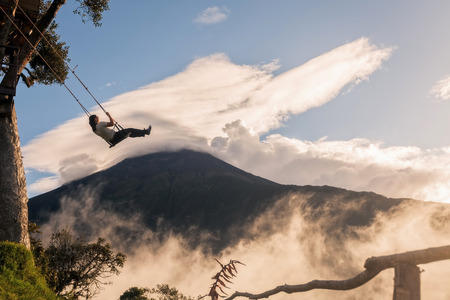 Banos, Ecuador - 25 November 2015: The Unique Location Swing Above Sea Level 2, 600 Meters Offers Visitors A Beautiful And Terrifying View Of The Tungurahua Volcano In Banos On November 25, 2015のeditorial素材