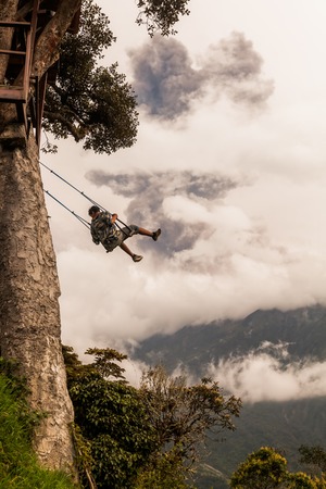 Banos De Agua Santa, Ecuador - 08 March 2016: Happy Adult Caucasian Man Swinging On A Swing In Banos...