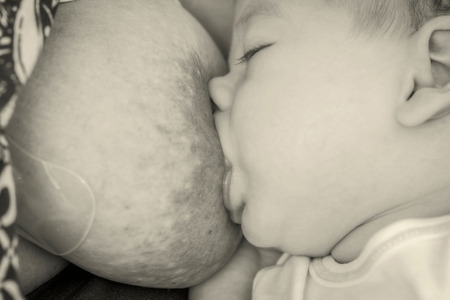 Mother Breast Feeding And Hugging Her Newborn Baby Boy, Monochrome Shootの写真素材