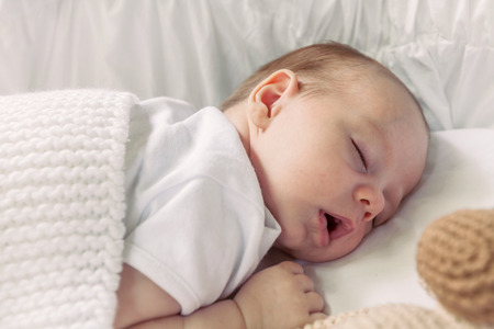 Sweet Little Newborn Baby Boy Sleeping On The Blanket With His Monkey Toyの写真素材