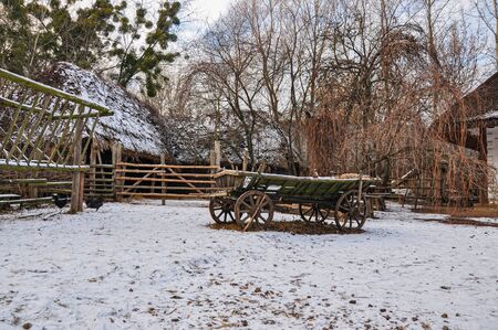 Old cart staying in Veranda near old house, old village of Ukraineの写真素材