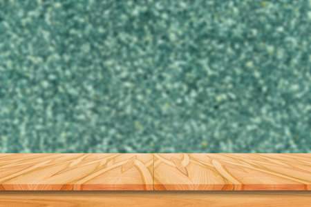 Empty wood table top and blur of stone wall background/selective focusの写真素材